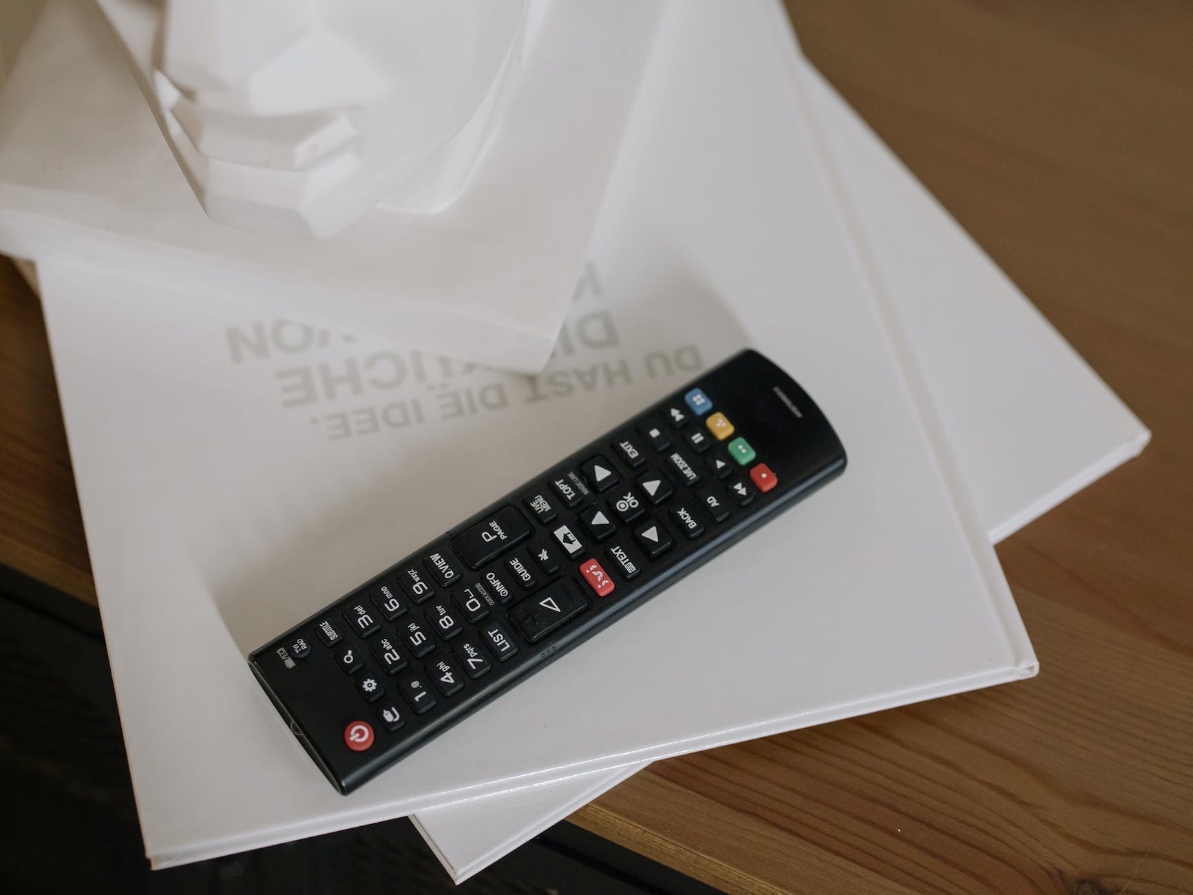 black samsung remote control on white paper